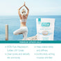 A woman practices yoga on a seaside deck with arms raised. In the foreground, San Francisco Salt Co Pure Epsom Salts - USP Grade sits, promoting muscle pain relief on a teal banner—ideal for a soothing soak after yoga.