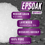 A close-up of white Epsom Salts - Everyday Sport Soothing crystals by San Francisco Salt Co, medium grain (0.2-3mm), infused with lavender essential oil for muscle recovery—dissolves quickly, 100% pure magnesium sulfate. Water droplets in the background.