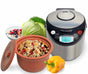 The VitaClay® Chef VITACLAY 7-IN-1 SMART ORGANIC MULTI-COOKER VM7900—a rice cooker, slow cooker, digital steamer, and bonus yogurt maker—featuring a digital display, is displayed beside a bowl of rice and vegetables, a yellow bell pepper, a head of cabbage, and a bowl of mixed fruit on a white background.