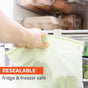 A hand puts Full Circle Compostable Zipper Snack Bags in a fridge with eggs and food on shelves. Text on image: RESEALABLE, fridge & freezer safe.