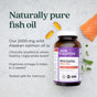A bottle of New Chapter Wholemega™ Fish Oil, Sustainably Caught Wild Alaskan Salmon Oil with Omega-3, is shown on a light background with herbs, raw salmon, and capsules. Text highlights its Omega-3 benefits and wild source.
