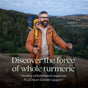 A bearded, smiling man in an orange jacket hikes with trekking poles and a backpack. Text: Discover Turmeric Force™ by New Chapter—supports healthy inflammation response plus heart & brain health.*.