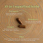 Two brown Zyflamend™ capsules from New Chapter sit on a wooden surface, with text promoting this 10-in-1 joint care supplement featuring superfood herbs like turmeric, rosemary, and ginger for natural inflammation relief.