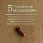 A brown capsule of New Chapter Daily Skin Renewal rests on wood. Above, text highlights five key skin ingredients like astaxanthin and collagen peptides, detailing their benefits for skin hydration and radiance.