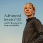 A woman in a black jacket stands outdoors under a blue sky. Text reads: Advanced D3 & K2 + Turmeric Capsules - for Bone, Heart, Immune & Cellular Energy Support by New Chapter.