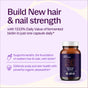 A bottle of Hair & Nail Defense Capsules - with Biotin for Healthy Hair Growth by New Chapter, packed with 1333% daily fermented biotin, keratin support, and astaxanthin for scalp and skin health.