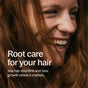 A smiling person with long, reddish-brown hair. Overlaid text reads: Support root health and boost growth with Hair Growth & Retention Capsules - Promote Natural Hair Growth and Scalp Vitality by New Chapter.