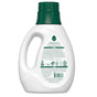 A white bottle of Concentrated Laundry Detergent by Seventh Generation has a green cap and side handle, is infused with essential oils for freshness, and showcases green text on the back label detailing usage, environmental certifications, and recycling info.