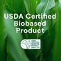 A background of green leaves features white text: USDA Certified Biobased Product. Below, the USDA Certified Biobased Product logo states Product 100%, spotlighting Seventh Generation Disinfectant Spray for use on nonporous surfaces.