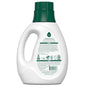 The white bottle of Seventh Generations Concentrated Laundry Detergent features a green cap and handle. The back label includes text and symbols, showcasing its triple-enzyme formula, eco-friendly and hypoallergenic properties, along with recycling symbols.