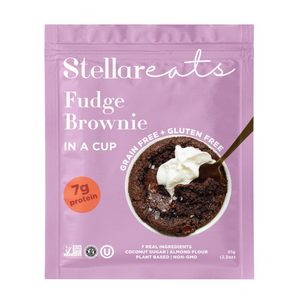 A pink pouch labeled Stellar Eats Fudge Brownie In A Cup displays a grain-free brownie with whipped cream and highlights this paleo-friendly dessert is gluten-free, plant-based, and has 7g protein.
