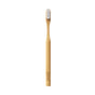 The Huppy Bamboo Toothbrush with Castor Oil Bristles stands upright on a white background, featuring a natural Moso bamboo handle with an engraved logo and eco-friendly white bristles.