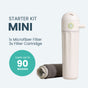 PlanetCare’s Starter Kit Mini Reusable Microfiber Filter attaches to your washing machine and comes with a gray microfiber filter and three cartridges for microplastic removal, each lasting up to 90 washes. One cartridge is upright; another lies next to the filter.