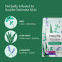 A package of HoneyPot Menstrual Pads - Herbal-Infused 100% Organic Cotton Cover is displayed, featuring illustrations of mint, aloe vera, and lavender to emphasize the soothing, cooling, and calming benefits these plant-based ingredients provide for intimate skin. The packaging highlights the herbal infusion and organic cotton cover in these HoneyPot sanitary pads.