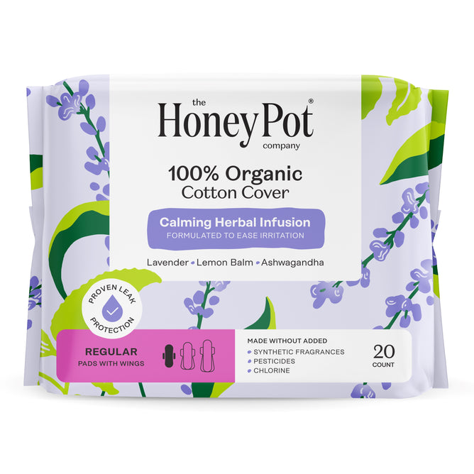 The Honeypot Company 100% Organic Cotton Cover Calming Herbal Infusion Regular Pads come in a purple pack with lavender designs, include 20 winged pads, and feature leak-proof protection plus calming ingredients like lavender and lemon balm.