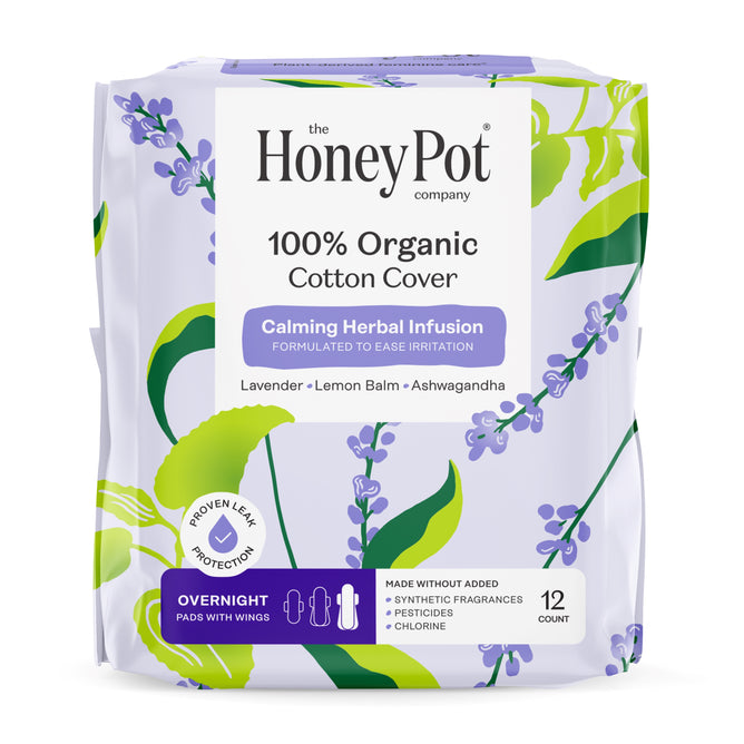 The Honeypot Company 100% Organic Cotton Cover Calming Herbal Infusion Overnight Pads offer leak-proof protection with wings. Each pack contains 12 pads infused with lavender, lemon balm, and ashwagandha. Lavender and leaf graphics decorate the package.