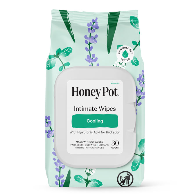 A package of HoneyPot Cooling Intimate Wipes - Herbal Infusion, featuring purple and green leaf designs, contains 30 hydrating wipes that are pH-balanced and free from added parabens, sulfates, dioxane, and synthetic fragrances.