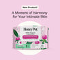 A package of HoneyPot Peri-menopause Long Liners - Harmonizing Herbal Infusion, featuring a 100% organic cotton cover and herbal-infused pads designed to support hormone balance, with floral designs, is displayed on a pink background with product description text above.