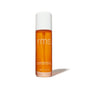 A cylindrical spray bottle of Kakadu Beauty Body Oil, a fast-absorbing, citrus-scented amber body oil topped with a white cap.