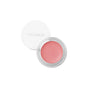 An open round pot of RMS Beauty Lip2cheek blush in soft pink, with a white lid, sits against a white background. This natural cream color is infused with wildcrafted buriti oil for moisturizing color and a radiant glow.