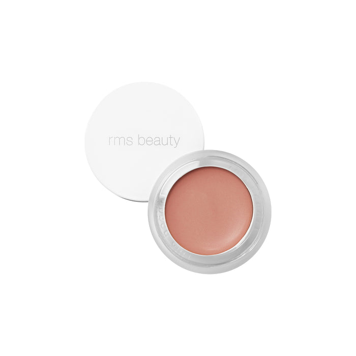 An open RMS Beauty Lip2cheek with a white lid reveals a peachy nude natural cream infused with wildcrafted buriti oil, photographed against a white background.