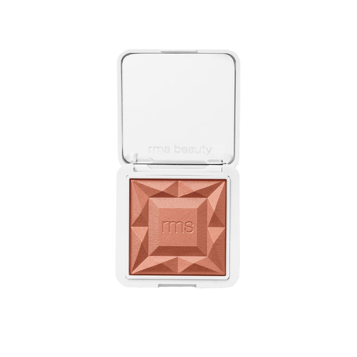 An open white compact reveals RMS Beautys ReDimension Hydra Powder Blush—a square, peach-toned, shimmer blush with clean ingredients and a faceted geometric design, finished with an rms emboss at the center.