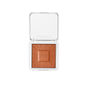 An open white refillable compact reveals the talc-free ReDimension Hydra Bronzer by RMS Beauty, featuring a shimmery sunburst design with rms embossed in the center and the brand name printed on the inside lid.