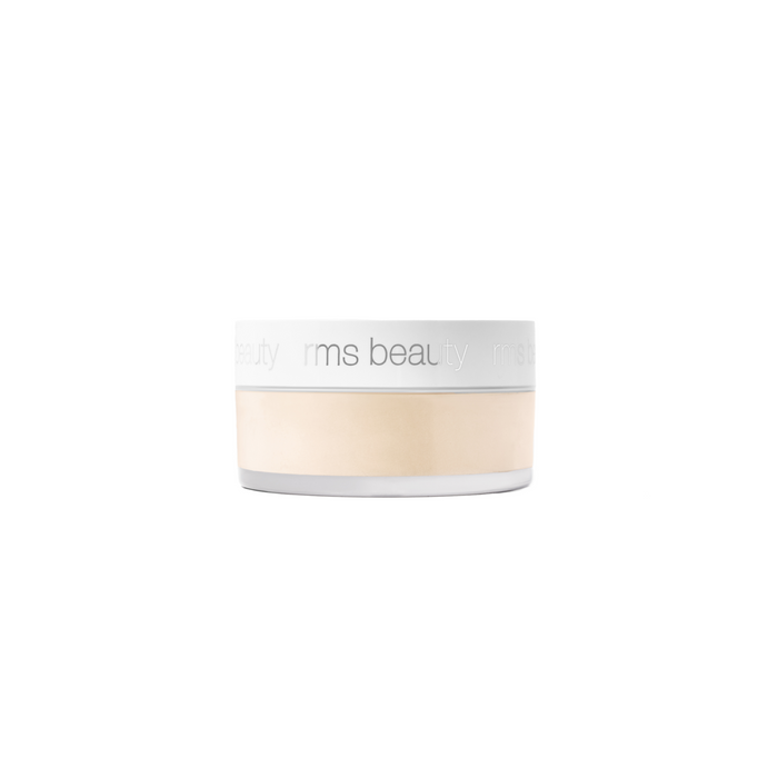 A small, round container of RMS Beauty Hydra Setting Powder with a white lid and clear base reveals light beige, talc-free powder inside. The RMS Beauty logo appears in light gray on the lid.