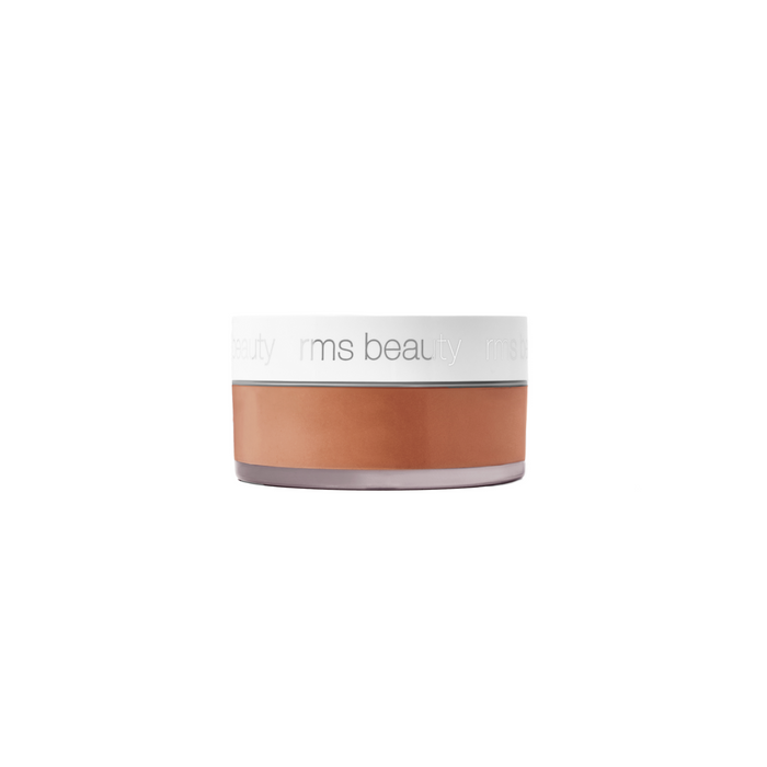 A round jar of RMS Beauty Hydra Setting Powder with a white lid and clear base, displaying the powder inside, set against a white background.