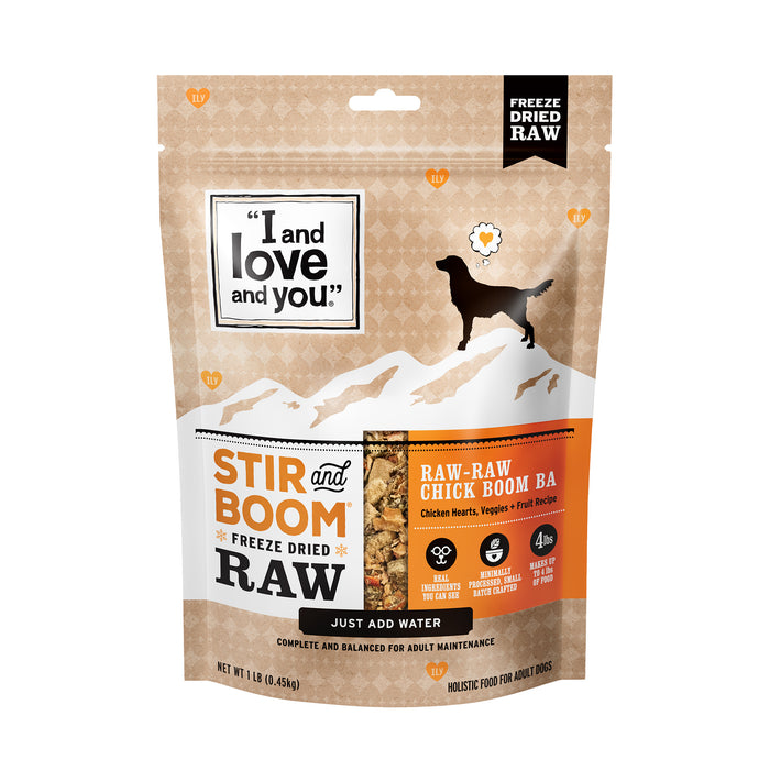 A package of I and Love and Yous Stir and Boom Raw Raw Chick Boom Ba Dinner, a grain-free dehydrated dog food featuring chicken hearts, veggies, and fruit, with a design showing a dogs silhouette against a mountain backdrop.