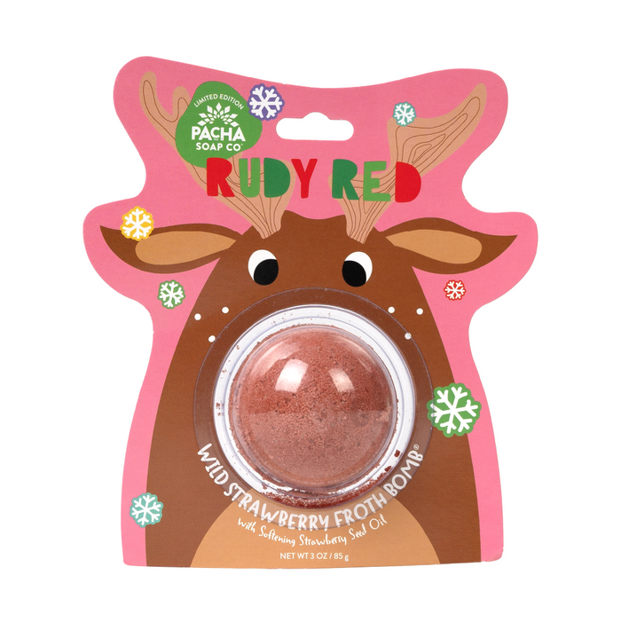 A round red bath bomb with Epsom salt is packaged on a card featuring a cartoon reindeer and reads "Pacha Soap Co. Bath Bomb Card - Rudy Red." Contains softening strawberry seed oil.