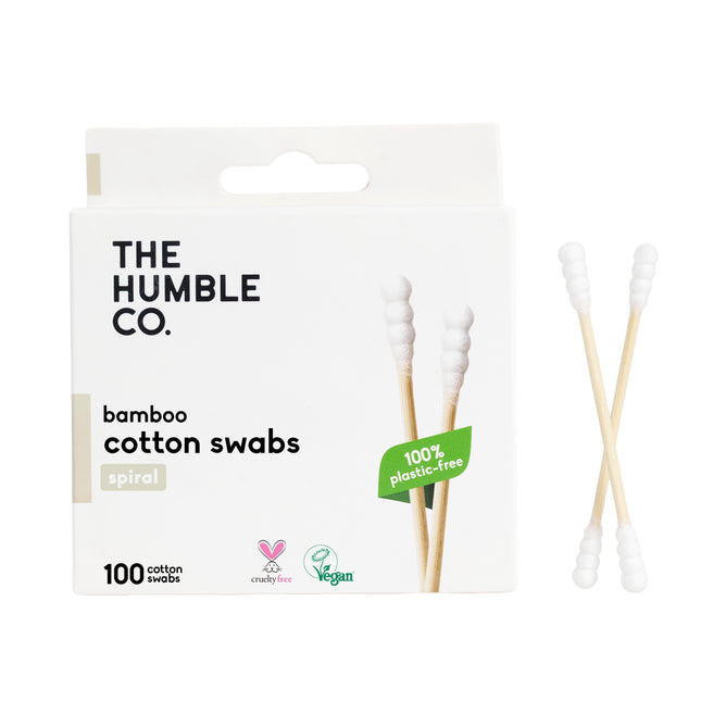 A box of The Humble Co. Cotton Swabs - Spiral Tip - White is pictured with two swabs beside it. The eco-friendly, 100% plastic-free packaging states they are cruelty-free, vegan, and ideal for makeup touchups. Contains 100 swabs.