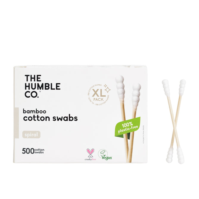 A box of The Humble Co. Cotton Swabs - Spiral Tip - White with two swabs beside it. The eco-friendly box, labeled “500 cotton swabs,” “100% plastic-free,” and “XL pack,” is vegan, cruelty-free, and great for makeup touchups.
