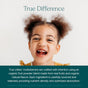 A young, curly-haired child smiles joyfully in a yellow shirt. Text below highlights the benefits of True Grace True Littles Daily Kids Multivitamin Gummies, made with organic fruit powder, natural flavors, and vegan vitamin D3.