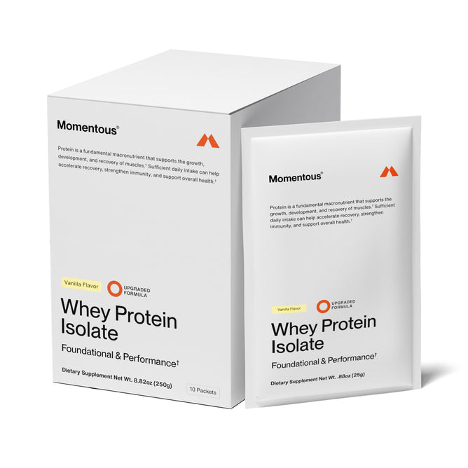 A box and packet of Momentous Whey Protein Single Serve in Vanilla. The white packaging features black text, orange accents, and highlights grass-fed protein with ProHydrolase for absorption—labeled Foundational & Performance.