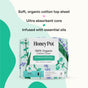 A pack of The Honeypot Company 100% Organic Cotton Cover Super Menstrual Pads - Herbal-Infused, shown with green and lavender accents. Text highlights soft organic cotton, ultra-absorbent core, and essential oil infusion.