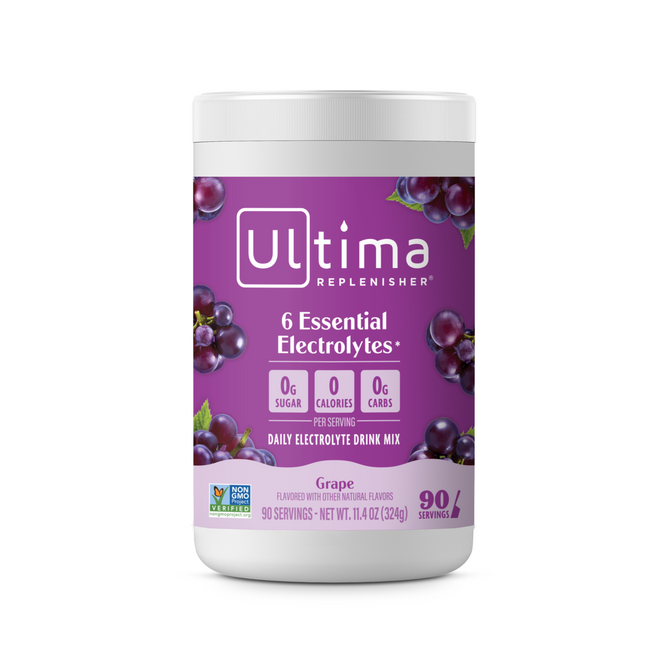 A purple container of Ultima Replenisher Broad Spectrum Electrolyte Mix for Hydration features grapes, a white lid, and labels: “6 Essential Electrolytes,” “0g sugar,” “0 calories,” “0g carbs”; highlights its sugar-free formula.