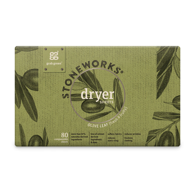 A box of grab green Stoneworks Dryer Sheets - Olive Leaf lays on a textured green background with olive leaves and olives. These 80 compostable sheets reduce static cling, naturally soften fabrics, and come in eco-friendly recycled paper packaging.