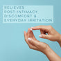 A hand applies Alubri Calming Intimate Cream for Itching & Sensitive Skin to a finger against a blue background. Text reads: Soothes post-intimacy discomfort and daily irritation, supporting the vaginal microbiome.