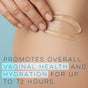 A hand applies Alubri Internal Vaginal Moisturizing Gel for Dryness & Comfort to skin. Overlaid text: Hydrates and supports the vaginal microbiome for up to 72 hours. Background is light blue.