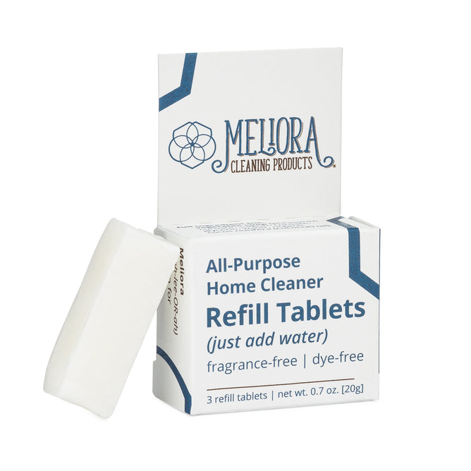 A box labeled Meliora All-Purpose Home Cleaner Refill Tablets with one white ultra-concentrated tablet leaning against it; the box indicates that the product is fragrance-free and dye-free.