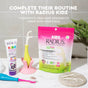 Kids oral care products on a bathroom counter: toothpaste, toothbrush, a pink cactus-shaped holder for eco-friendly kids floss picks, compostable floss picks, and a pink pouch labeled Radius Kids EcoFlex™ Refill Bag. Text above describes the products.