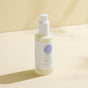 A bottle of Wildcraft Calm Face Lotion, a lightweight hydrating moisturizer, rests on a light beige surface with soft shadows in the background.