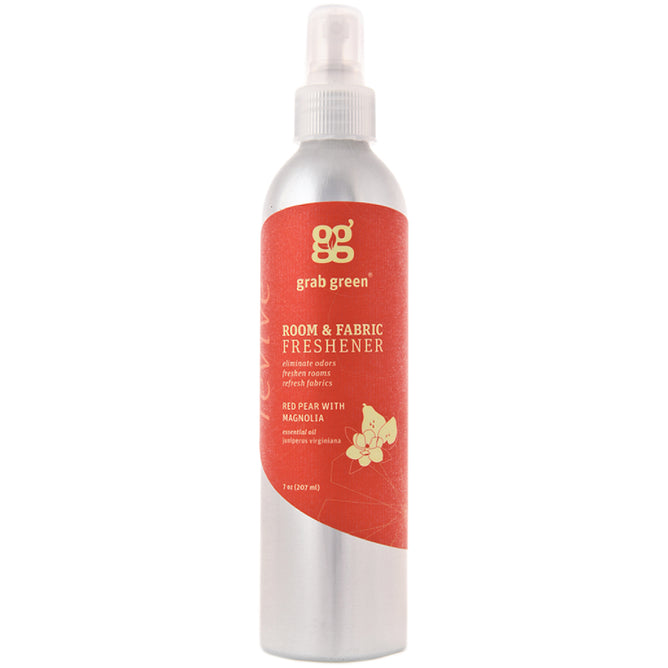 A silver spray bottle by grab green features a red label for Room and Fabric Freshener - Red Pear with Magnolia, enriched with essential oils. It has a floral design and serves as an odor-neutralizer, complete with a clear spray nozzle for easy application.