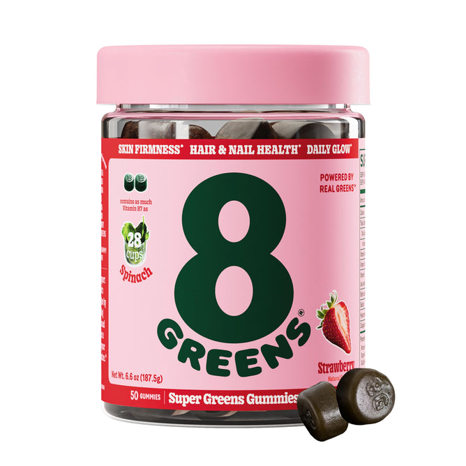A jar of 8Greens Super Greens Gummies - Beauty with a pink lid promises skin firmness and hair/nail health for a daily glow. Bursting with strawberry flavor, they provide nutrients equal to 28 cups of spinach. Two gummies are beside the jar.