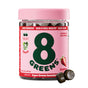 A jar of 8Greens Super Greens Gummies - Beauty with a pink lid promises skin firmness and hair/nail health for a daily glow. Bursting with strawberry flavor, they provide nutrients equal to 28 cups of spinach. Two gummies are beside the jar.