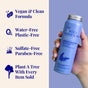 A hand holds a blue bottle of The Powder Shampoo’s Relaxing Night Body Foam Wash. Text highlights: vegan, clean formula with Butterfly Pea Flower Extract, water-free, plastic-free, sulfate- & paraben-free, and a tree planted per item sold.