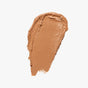 Axiology Fungdation - Mushroom Foundation creates a smooth, even smear of medium brown hydration on a white background.