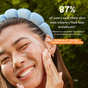 A smiling person with clear skin touches their cheek, highlighting the results of the Jelly Drops Routine Kit by Three Ships. 87% of users reported clearer skin and fewer breakouts after 2 weeks. Clinically- and dermatologist-tested.