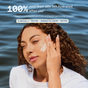 A woman with curly hair applies Three Ships Jelly Drops Routine Kit cream outdoors, enjoying glowing hydration. Text reads, 100% felt hydrated after use in a 2-week study. Blue label: Clinically-tested + Dermatologist-tested.